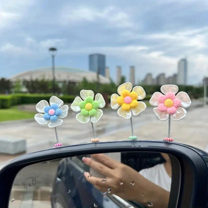 Slinger van margrietjes voor in de auto