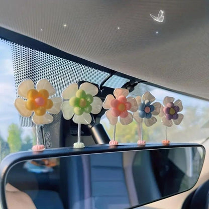 Slinger van margrietjes voor in de auto