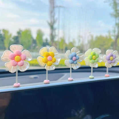 Slinger van margrietjes voor in de auto